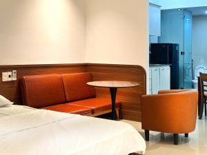 a room with a bed and a table and chairs at NOAM Stay - Sea Corner in Danang
