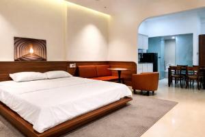 a bedroom with a bed and a dining room at NOAM Stay - Sea Corner in Danang