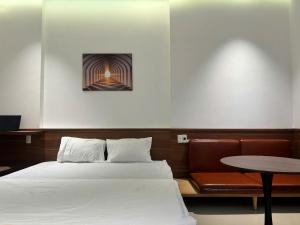 a bedroom with a bed and a table in it at NOAM Stay - Sea Corner in Danang