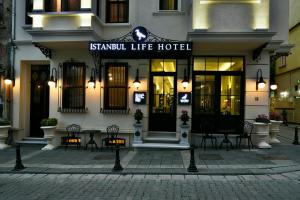 a hotel with tables and chairs in front of a building at Istanbul Life Hotel in Istanbul
