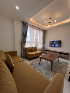 a living room with a couch and a table at Zemilo Hotel Apartment in Addis Ababa