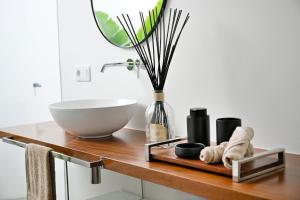 a bathroom with a sink and a bowl on a wooden table at Casa Alisios Sea View Villa private Infinity Pool Sunsets in La Pared