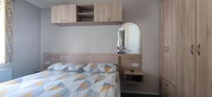 a bedroom with a bed and a mirror at Billing Aquadrome ,2 bedrooms, Royale Poplar KM 12 in Great Billing +69 photos