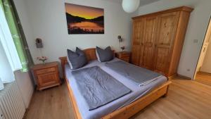 a bedroom with a large bed with a wooden frame at Allgäuer Ausblick in Missen-Wilhams +113 photos