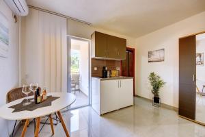 a kitchen with a white table and a white counter top at Ferienwohnung Nike's in Dobra Voda