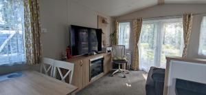 a living room with a flat screen tv and a entertainment center at Billing Aquadrome ,2 bedrooms, Royale Poplar KM 12 in Great Billing