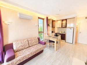 a living room with a couch and a table at Harmony Dream Island 9 Private Apartment 618 in Sunny Beach