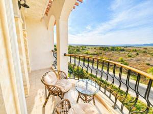 a balcony with chairs and tables and a view at Harmony Dream Island 9 Private Apartment 618 in Sunny Beach