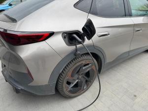 a silver car is being charged by a wire at Apartament_Zbąszyń in Zbąszyń