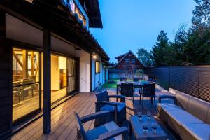 a patio with tables and chairs on a deck at Anto Azumino in Azumino +56 photos