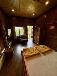 a room with a bed and a chair in it at Ashaya Agro Farms in Umberpāda