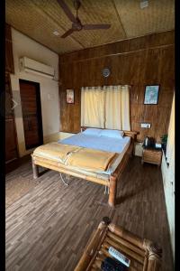 a large bed in a room with a ceiling at Ashaya Agro Farms in Umberpāda