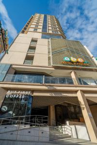a tall building with a sign on it at ABC Plus Hotel & Homes in Cebu City