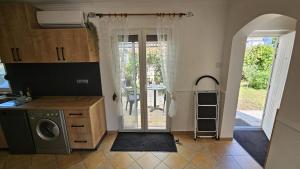 a kitchen with a door leading to a patio at Ferienhaus Grüne Oase in Bar