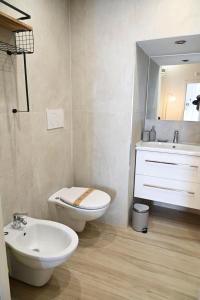 a bathroom with a toilet and a sink and a mirror at DreamHouse in Bari