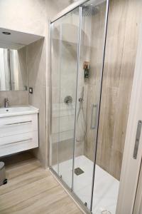 a shower with a glass door in a bathroom at DreamHouse in Bari