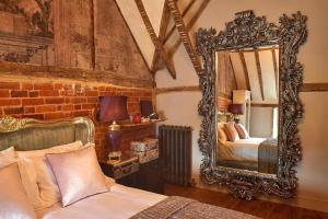 a bedroom with a mirror and a bed in it at Broad Leys in Aylesbury