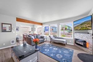 a living room with a couch and a fireplace at Sunkissed 3BR Oceanview, Dog-Friendly Beach Home in Pacific Beach