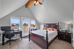 a bedroom with a bed and a desk with a computer at Sunkissed 3BR Oceanview, Dog-Friendly Beach Home in Pacific Beach