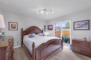 a bedroom with a bed and a dresser and a window at Sunkissed 3BR Oceanview, Dog-Friendly Beach Home in Pacific Beach +45 photos