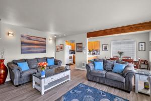 a living room with two couches and a table at Sunkissed 3BR Oceanview, Dog-Friendly Beach Home in Pacific Beach