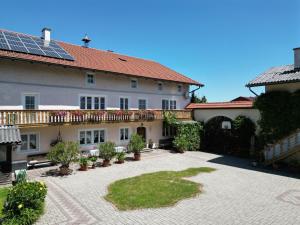 a house with solar panels on the roof at Pension Seehof in Holzöster