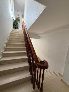 a stairway with a wooden rail and a stair case at Hostal La Perla in Zalamea de la Serena