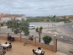 a view of a parking lot with a white van at Hostal La Perla in Zalamea de la Serena