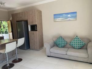 a living room with a couch and a table at Villa Ti Amo Flat in Ramsgate +4 photos