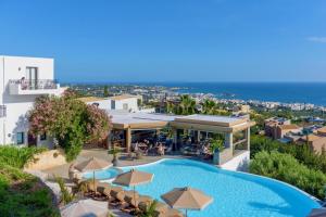 an image of a resort with a swimming pool and umbrellas at Creta Blue Boutique Hotel in Hersonissos