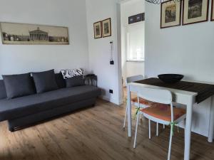 a living room with a couch and a table at Il cappero in La Spezia