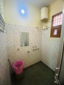 a bathroom with a pink toilet and a mirror at Negi Lodge Chandigarh in Chandīgarh +50 photos