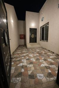 a hallway with a tiled floor in a building at شاليهات حديقة الوسام لبيوت العطلات 1 in Taif