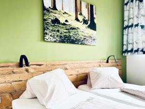 two beds with white pillows and a painting on the wall at Haus Leitner in Attersee am Attersee +93 photos