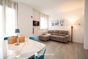 a living room with a couch and a table at Garda Nest in Padenghe sul Garda