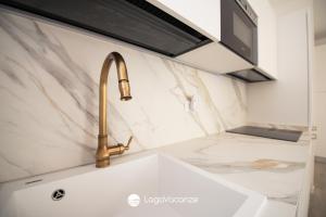 a kitchen with a sink and a faucet at Garda Nest in Padenghe sul Garda +24 photos