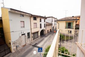an empty street in a town with buildings at Garda Nest in Padenghe sul Garda