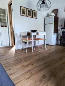 a kitchen with a table and chairs and a refrigerator at Il cappero in La Spezia