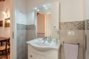 a white bathroom with a sink and a shower at Casa Loretta Vicopisano in Vicopisano +19 photos