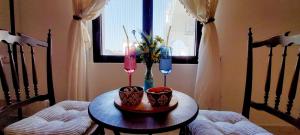 a small table with two candles and flowers on it at Villa Mare Presepe in Torchiarolo +64 photos