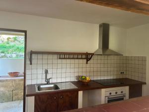 a kitchen with a sink and a counter top at Tramuntana Sunset in Port de Soller +23 photos