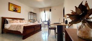 a bedroom with a bed and a desk with a computer at Villa Mare Presepe in Torchiarolo