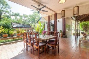 an outdoor dining room with a table and chairs at Southern Lanta B9 in Ko Lanta
