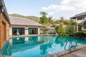 a swimming pool in front of a house at Southern Lanta B9 in Ko Lanta
