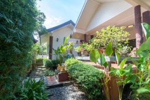 a garden in front of a house with plants at Southern Lanta B9 in Ko Lanta
