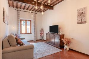 a living room with a couch and a tv at Casa Ilaria Vicopisano in Vicopisano
