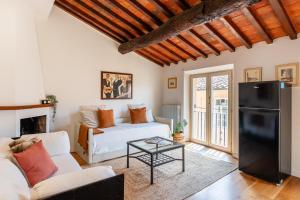 a living room with a couch and a table at Mordini Loft - 3 Bedrooms - Lucca in Lucca