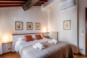 a bedroom with a bed with two towels on it at Mordini Loft - 3 Bedrooms - Lucca in Lucca