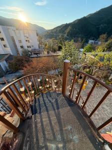 a wooden staircase leading to a balcony with the sunset at Guest house Luli Mucaj in Çorovodë