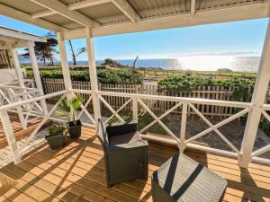 a porch with chairs and a view of the ocean at Winford Manor in Murdoch Valley